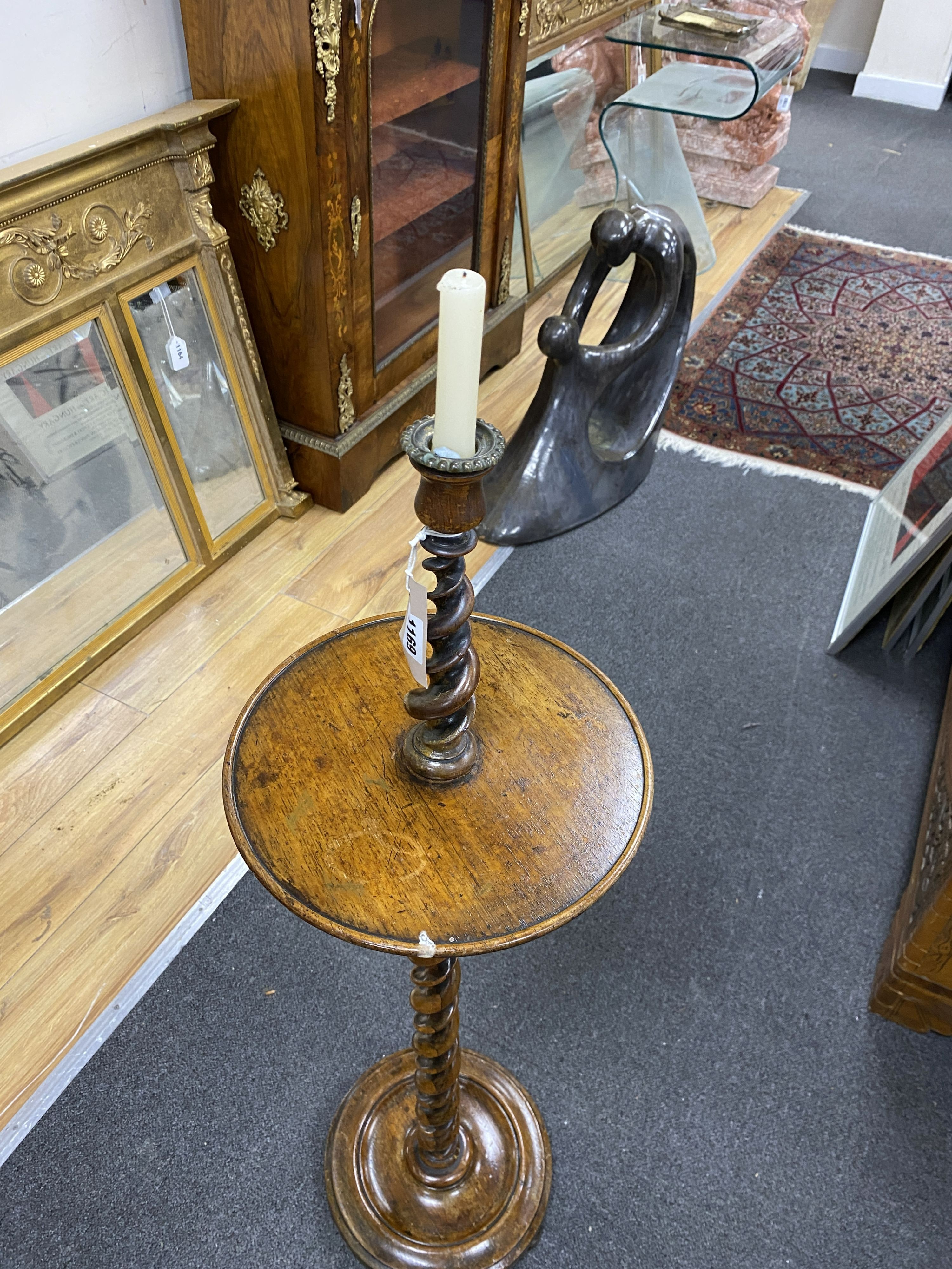 An early 20th century twist column oak and rosewood floor candlestand, height 99cm